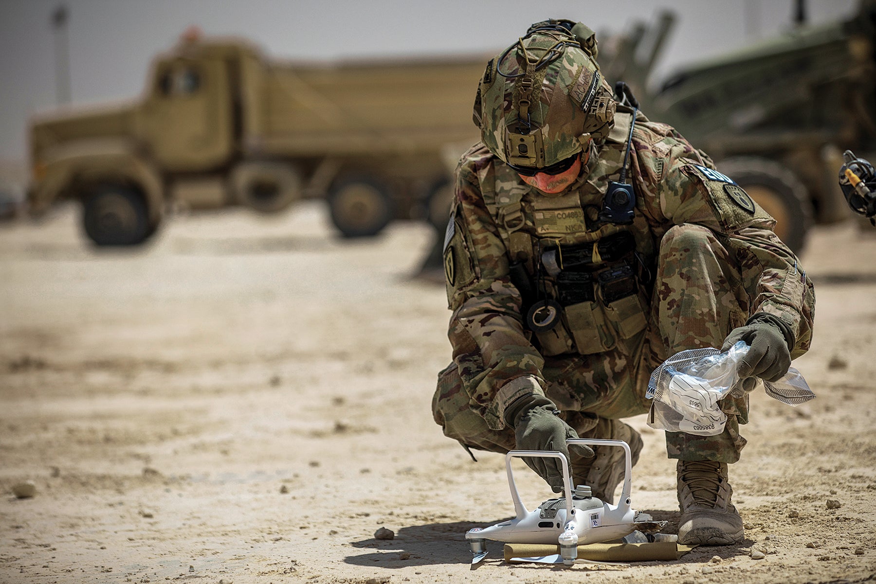 Sgt. 1st Class Adrian Coghill, an explosive ordnance disposal technician, sets up a remote-controlled ordnance disposal drone at the Ain al-Asad air base, Iraq. (Credit: U.S. Army/Spc. Derek Mustard)