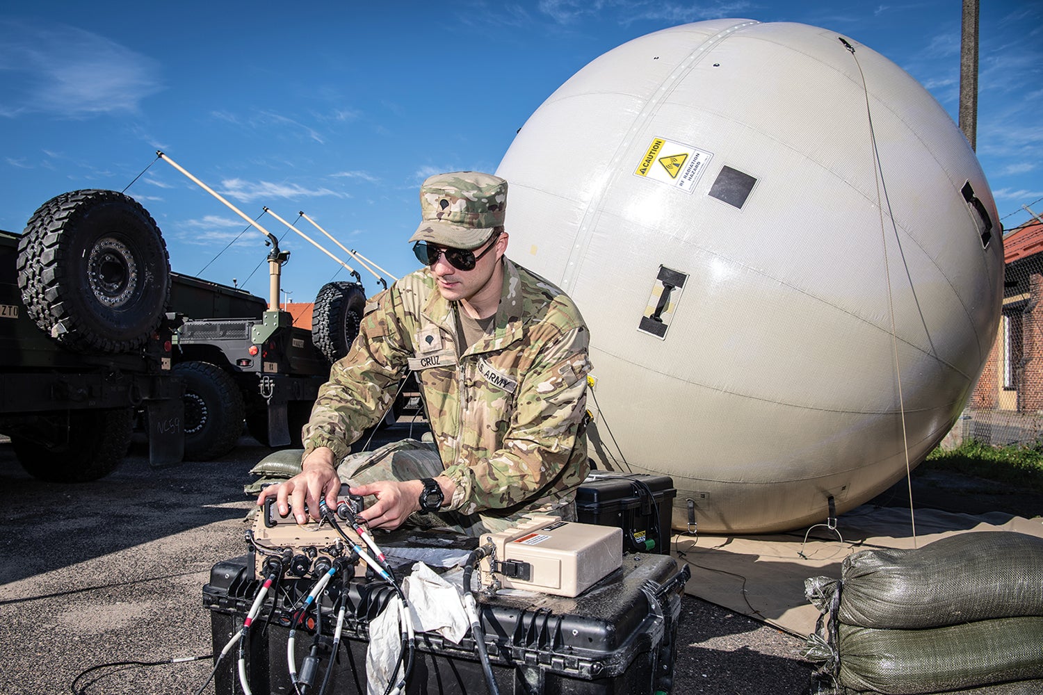 A soldier sets up a Combat Service Support Very Small Aperture Terminal for satellite communications. (Credit: Courtesy Photo)