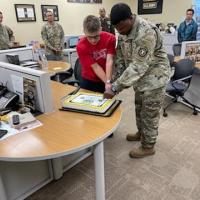 Future soldier Jeffrey Labarbara and SSG Jartavious Martin cut the birthday cake.