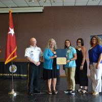 Cadet Angela Lange receives her scholarship from President Dr. Cynthia Gatto and MG Timothy Thombleson