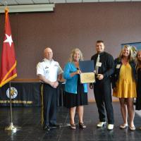 Cadet Logan Notaro receives his scholarship from President Dr. Cynthia Gatto and MG Timothy Thombleson