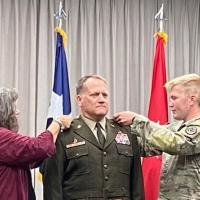 MG Aris' family (wife & son) pinning on his two stars for  promotion to Major General