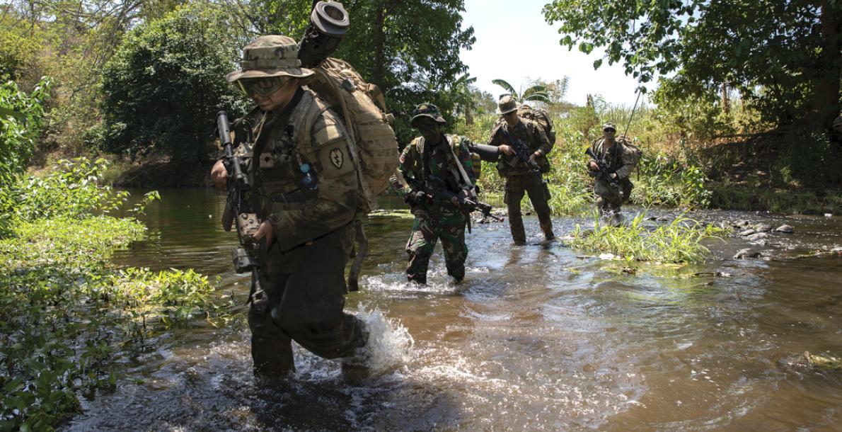 Soldiers with the 2nd Brigade Combat Team, 25th Infantry Division, and an Indonesian soldier patrol along a river during a joint exercise in Indonesia. (Credit: U.S. Army/Staff Sgt. Alex Manne)