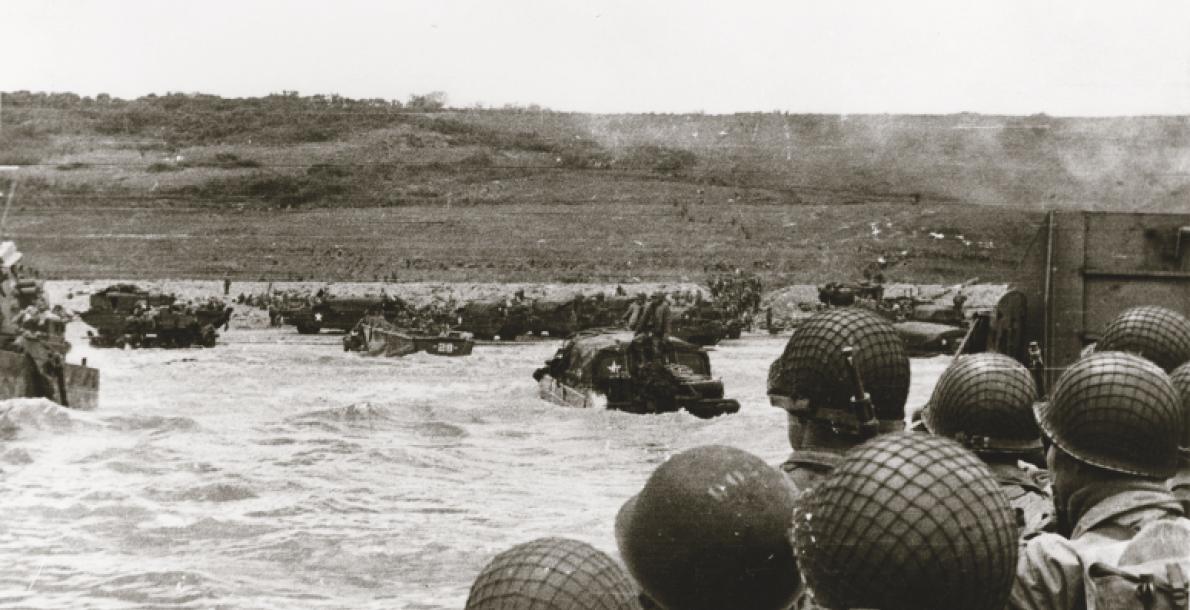 U.S. soldiers look ahead as their landing craft approaches Omaha Beach, Normandy, France, on D-Day. (Credit: U.S. Navy)