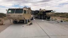 Two heavily damaged M1120A4 trucks