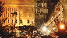 At the Pentagon, firefighters battle smoke and flames and search for survivors late into the night of Sept. 11, 2001, after a hijacked airliner crashed into the building.