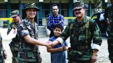 Then-Col. George Alexander, left, greets an Ecuadorian army commander and his son during a medical readiness training exercise in Ecuador in 1996.
