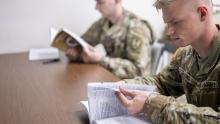 Pfc. Bryce Grafing, right, a paralegal specialist with the U.S. Army Reserve’s 300th Military Police Brigade, 200th Military Police Command, reads instructional material during a class at Fort McCoy, Wisconsin. (Credit: U.S. Army/Staff Sgt. Ryan Rayno)