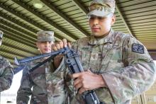 Second Lt. Kevin Luna-Torres assembles an M240B machine gun during a weapons familiarization course at Fort Knox, Kentucky.