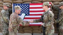 Capt. Kevin Livingston, left, congratulates Staff Sgt. Katelyn Simon after she reenlists at Erbil Airbase, Iraq, in December 2022. Both soldiers are with the Ohio National Guard’s 37th Infantry Brigade Combat Team. (Credit: Army National Guard/Staff Sgt. Scott Fletcher)