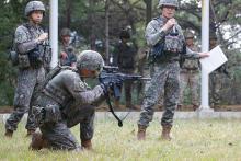 A Republic of Korea soldier demonstrates procedures for operating his military’s K1A carbine in South Korea.