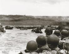 U.S. soldiers look ahead as their landing craft approaches Omaha Beach, Normandy, France, on D-Day. (Credit: U.S. Navy)