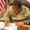 U.S. Army South commander Maj. Gen. William Thigpen signs a document at his headquarters in San Antonio. (Credit: U.S. Army/Master Sgt. Alex Ramos)