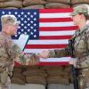 Capt. Kevin Livingston, left, congratulates Staff Sgt. Katelyn Simon after she reenlists at Erbil Airbase, Iraq, in December 2022. Both soldiers are with the Ohio National Guard’s 37th Infantry Brigade Combat Team. (Credit: Army National Guard/Staff Sgt. Scott Fletcher)